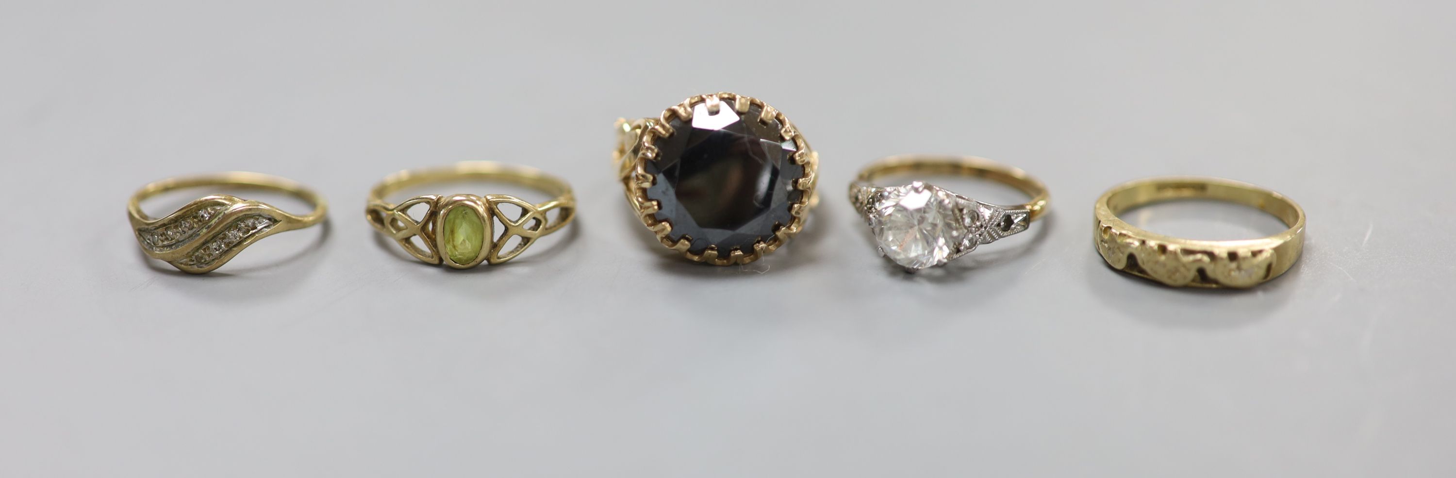 Five assorted modern 9ct gold and gem set dress rings including white zircon